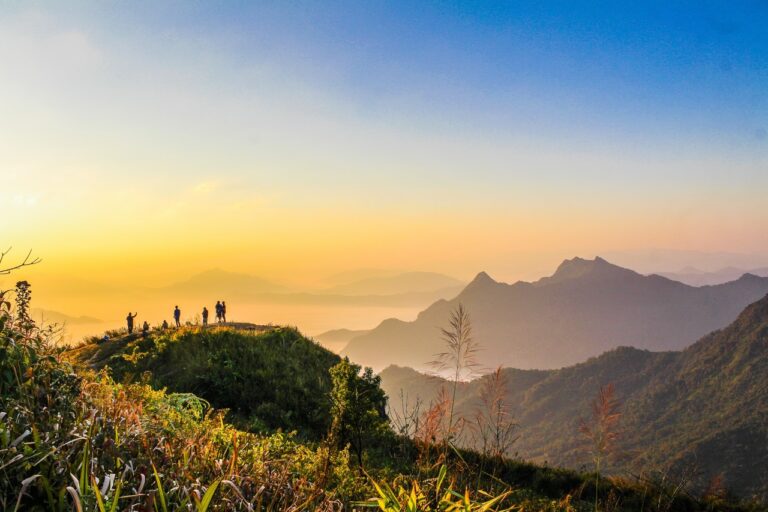 Photo Of People Standing On Top Of Mountain Near Grasses 733162 768x512